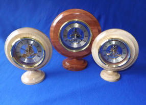 Smaller Clock approx 180mm Dia. Oak surround - £50.